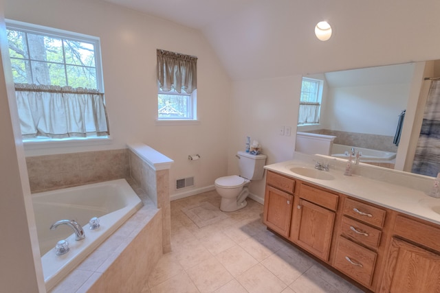 bathroom featuring healthy amount of natural light, toilet, double vanity, a bath, and vaulted ceiling