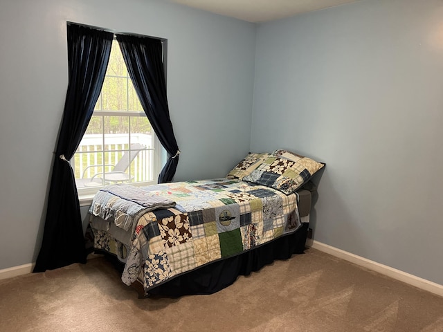 carpeted bedroom featuring baseboards