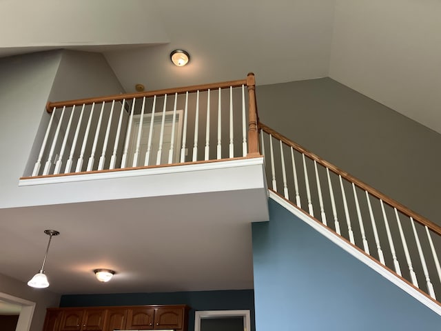 staircase with lofted ceiling