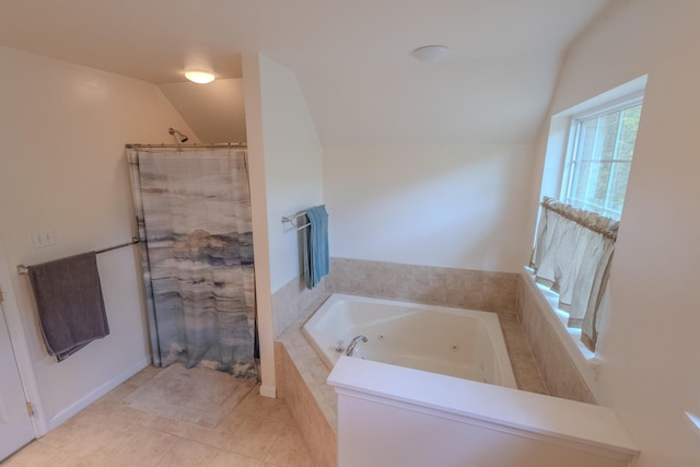 bathroom with vaulted ceiling, a shower with shower curtain, a tub with jets, and tile patterned floors