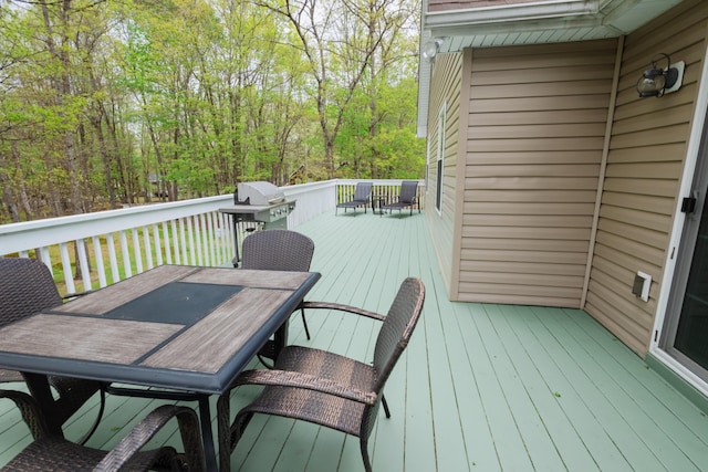 wooden terrace with outdoor dining space