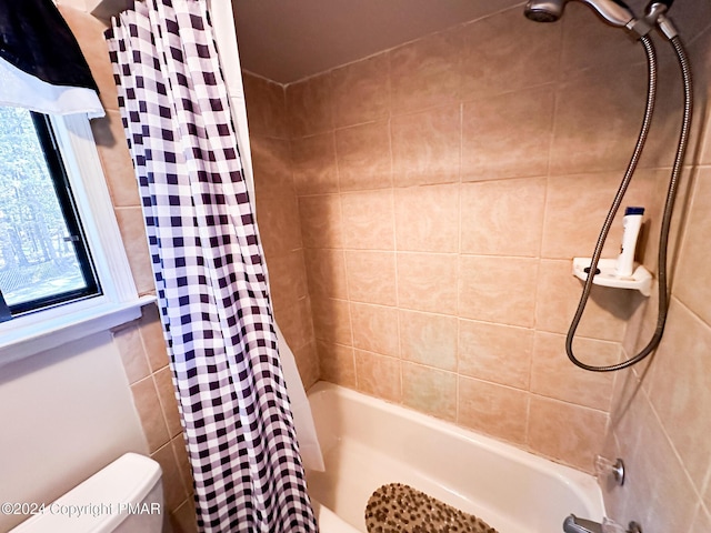 bathroom with shower / bath combo and toilet