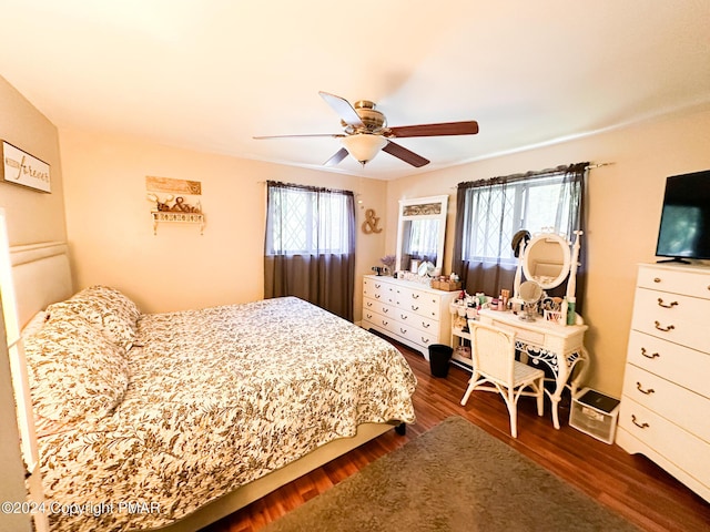 bedroom with dark wood-style floors and a ceiling fan