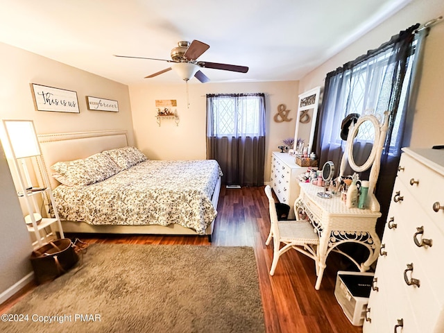 bedroom featuring a ceiling fan and dark wood-type flooring