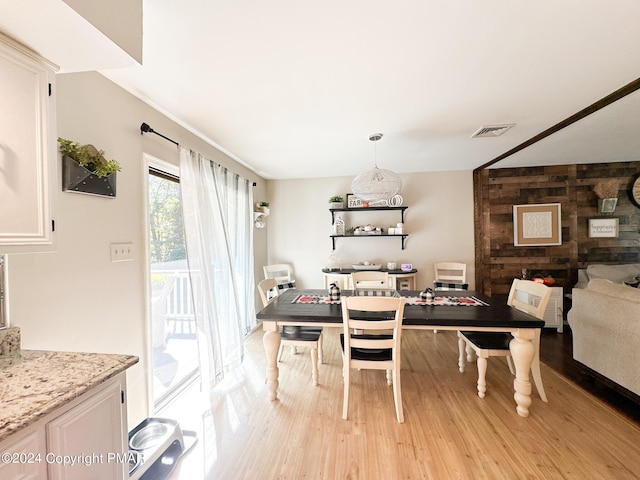 dining room featuring light wood-style flooring and visible vents