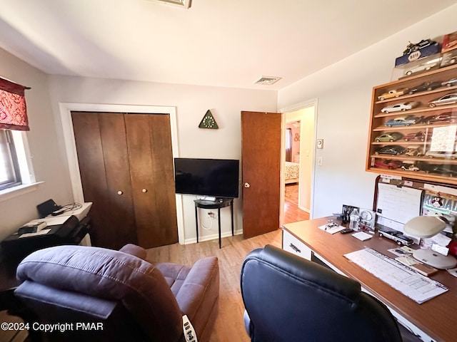 office area with visible vents and wood finished floors