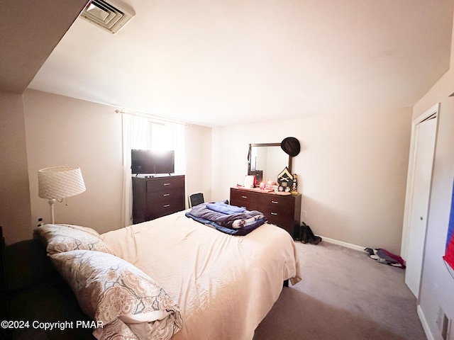 bedroom with carpet floors, visible vents, and baseboards