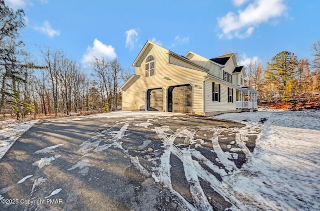 view of side of home with a garage and driveway