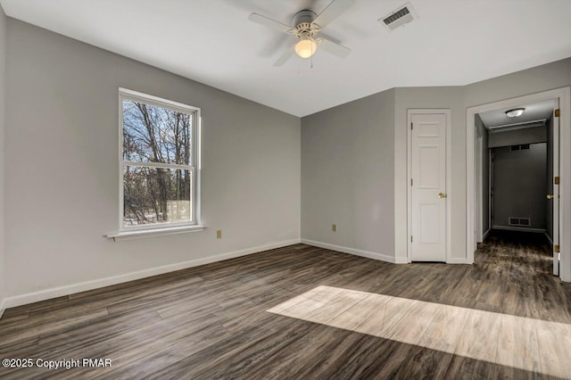 unfurnished bedroom with visible vents, baseboards, and wood finished floors