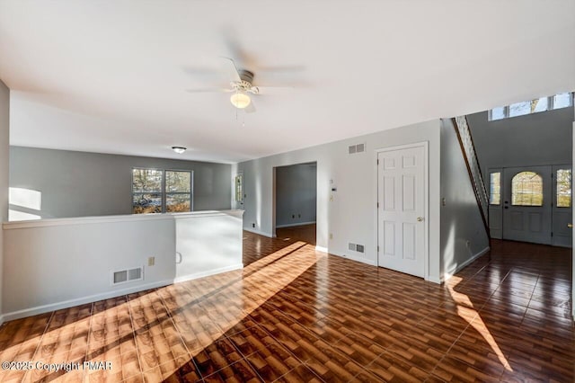 interior space with wood finished floors, visible vents, and baseboards