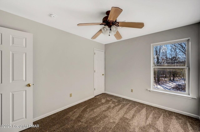 unfurnished bedroom featuring ceiling fan, carpet, and baseboards