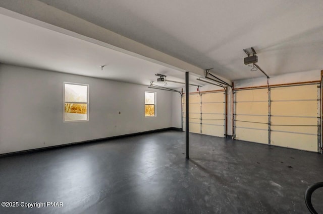 garage with a garage door opener and baseboards