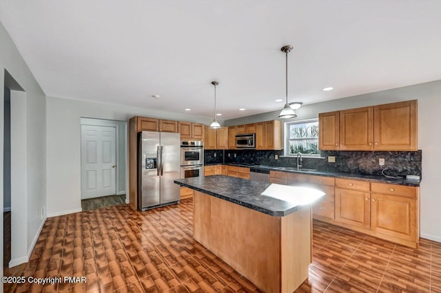 kitchen featuring tasteful backsplash, dark countertops, appliances with stainless steel finishes, light wood-style floors, and a sink