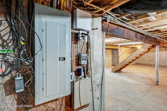 unfinished basement with electric panel and stairs