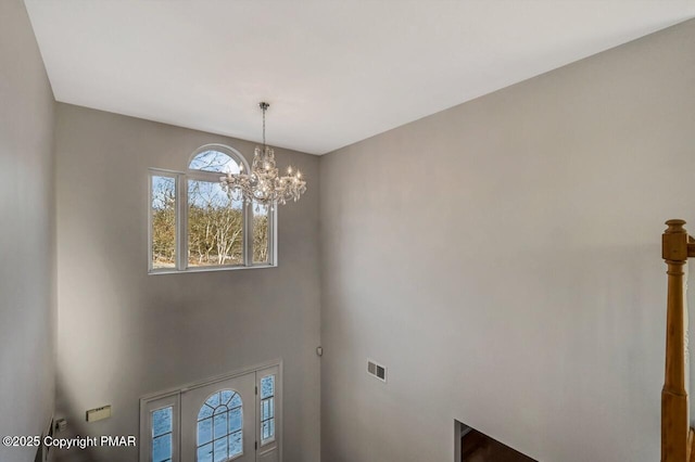 interior space with visible vents and a notable chandelier