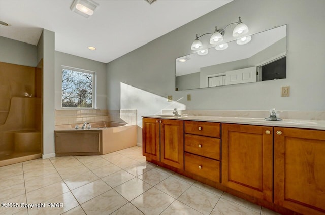 full bath with a garden tub, double vanity, tile patterned flooring, and a sink