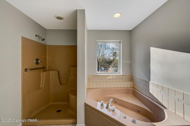 bathroom with walk in shower and a bath