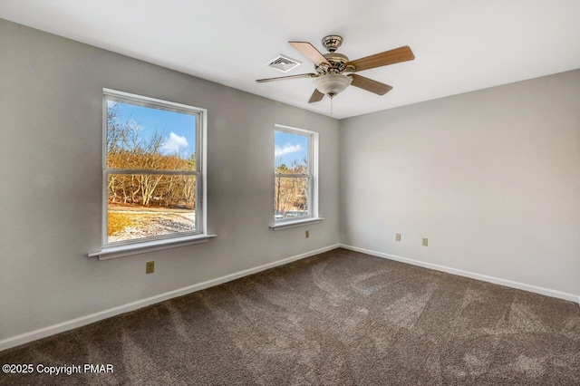 carpeted empty room with visible vents, ceiling fan, and baseboards