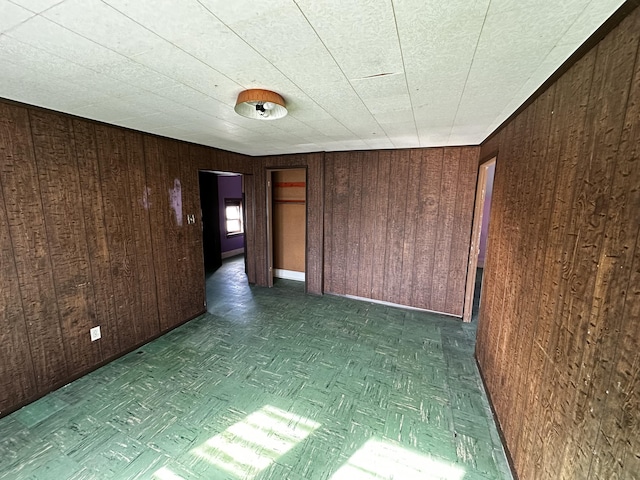 empty room featuring wooden walls