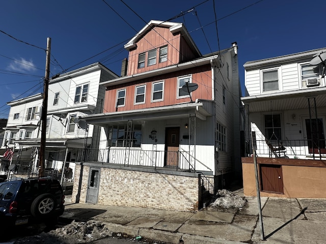 view of front of home with cooling unit and a porch