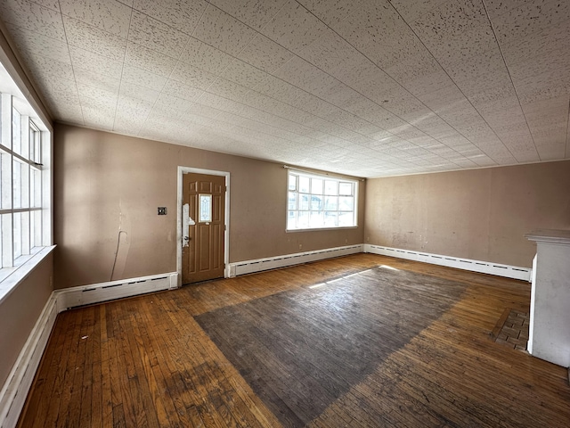 entrance foyer with a baseboard radiator and hardwood / wood-style floors