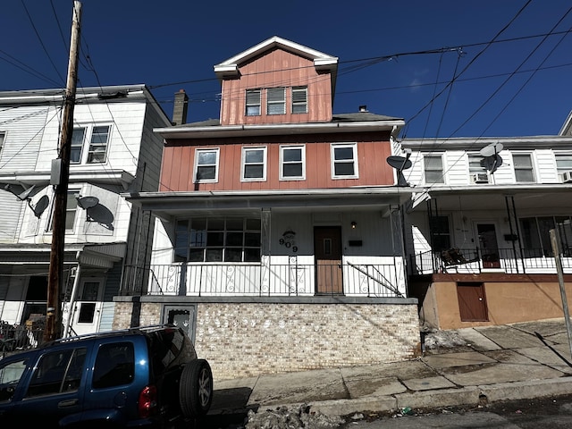 view of property featuring covered porch