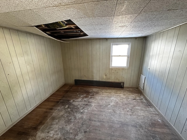 basement with wood finished floors and a baseboard radiator