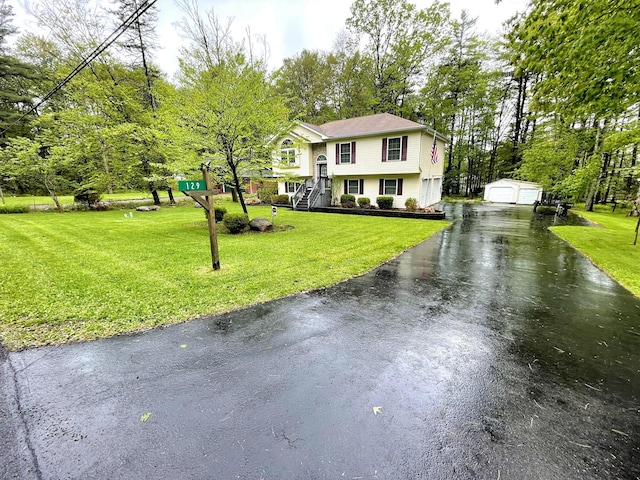 129 Birchwood Rd, Blakeslee, PA 18610 - raised ranch with an outbuilding, driveway, a front yard, and a detached garage