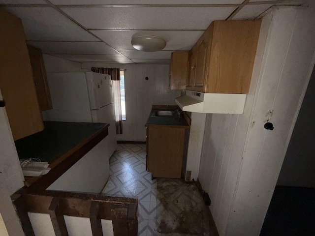 5 S 9th St, Stroudsburg, PA 18360 - kitchen with a paneled ceiling, light flooring, freestanding refrigerator, and wood walls