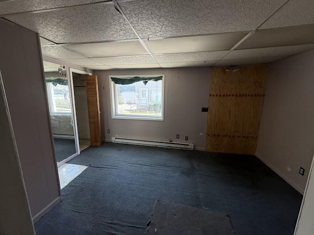 5 S 9th St, Stroudsburg, PA 18360 - spare room featuring baseboard heating, a drop ceiling, carpet floors, and a baseboard heating unit