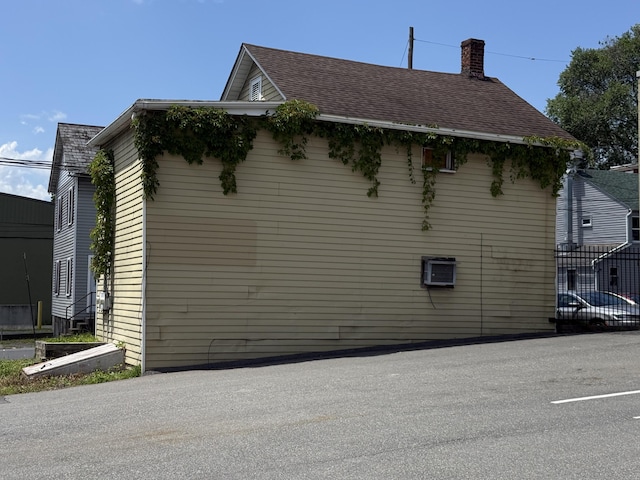 5 S 9th St, Stroudsburg, PA 18360 - view of property exterior featuring a chimney and roof with shingles