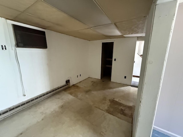 5 S 9th St, Stroudsburg, PA 18360 - below grade area with a paneled ceiling, an AC wall unit, and a baseboard heating unit