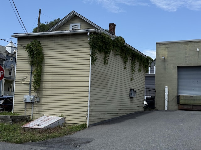 5 S 9th St, Stroudsburg, PA 18360 - view of property exterior featuring a chimney and a garage