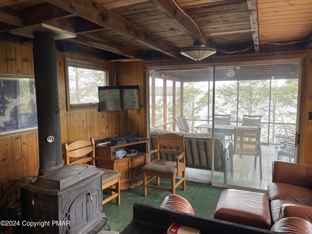 sunroom featuring beam ceiling