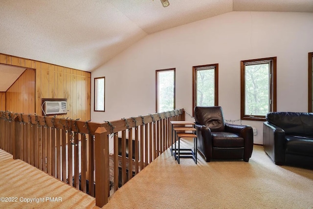 138 Banbury Dr, Bushkill, PA 18324 - living area with lofted ceiling, plenty of natural light, carpet floors, a wall mounted AC, and an upstairs landing
