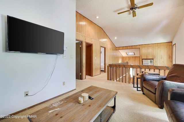 138 Banbury Dr, Bushkill, PA 18324 - living room featuring lofted ceiling, light carpet, wooden walls, and ceiling fan