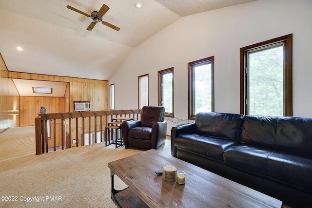 138 Banbury Dr, Bushkill, PA 18324 - living room featuring carpet floors, wood walls, vaulted ceiling, ceiling fan, and a wall mounted AC