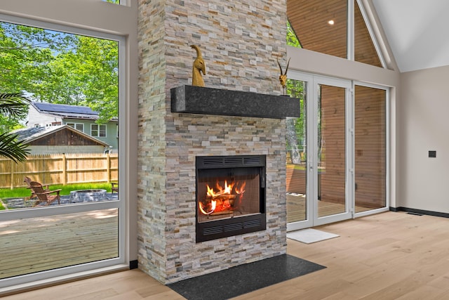 2154 Valleyview Dr, Bushkill, PA 18324 - unfurnished living room with wood finished floors, lofted ceiling, and an outdoor stone fireplace