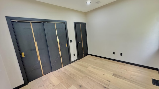 2154 Valleyview Dr, Bushkill, PA 18324 - unfurnished bedroom featuring light wood-type flooring, baseboards, two closets, and recessed lighting