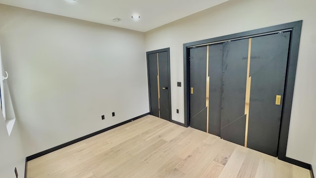 2154 Valleyview Dr, Bushkill, PA 18324 - unfurnished bedroom featuring light wood-style floors, recessed lighting, baseboards, and multiple closets