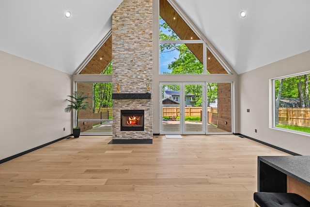 2154 Valleyview Dr, Bushkill, PA 18324 - unfurnished living room with high vaulted ceiling, a fireplace, baseboards, wood finished floors, and recessed lighting