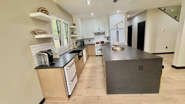 2154 Valleyview Dr, Bushkill, PA 18324 - kitchen featuring dark countertops, premium appliances, under cabinet range hood, open shelves, and a center island