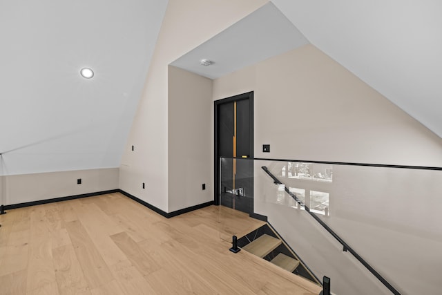 2154 Valleyview Dr, Bushkill, PA 18324 - stairs with lofted ceiling, wood finished floors, and baseboards