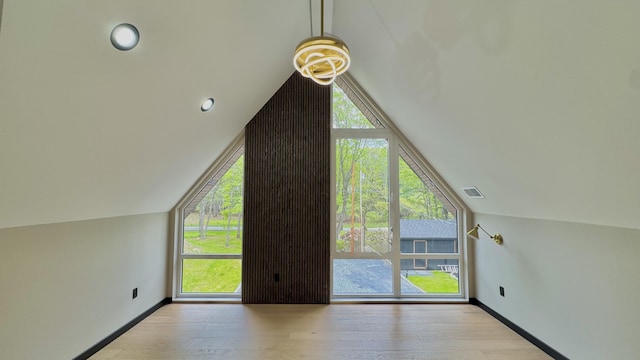 2154 Valleyview Dr, Bushkill, PA 18324 - additional living space featuring lofted ceiling, healthy amount of natural light, hardwood / wood-style flooring, and baseboards