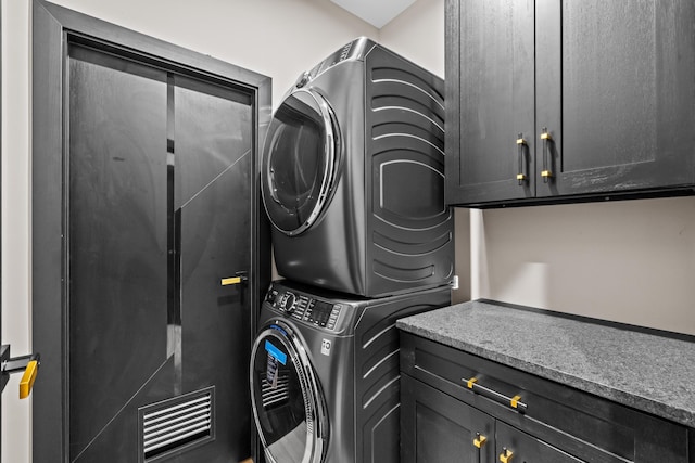 2154 Valleyview Dr, Bushkill, PA 18324 - laundry area with stacked washer and clothes dryer and cabinet space