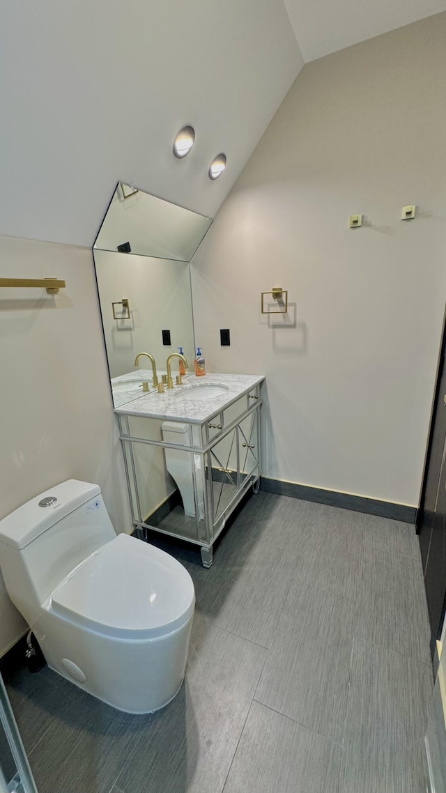 2154 Valleyview Dr, Bushkill, PA 18324 - bathroom featuring vanity, vaulted ceiling, toilet, and baseboards