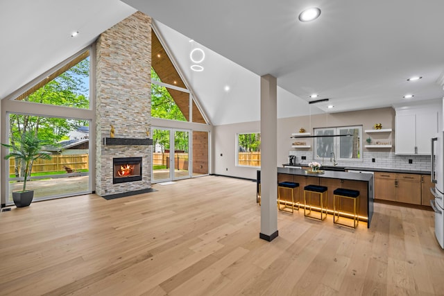 2154 Valleyview Dr, Bushkill, PA 18324 - living area with light wood finished floors, high vaulted ceiling, a fireplace, baseboards, and recessed lighting
