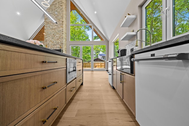 2154 Valleyview Dr, Bushkill, PA 18324 - kitchen featuring light wood-style floors, high vaulted ceiling, dishwasher, oven, and dark countertops