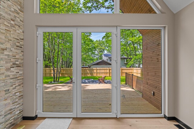 2154 Valleyview Dr, Bushkill, PA 18324 - kitchen with stainless steel microwave, open floor plan, light wood-style flooring, a fireplace, and lofted ceiling