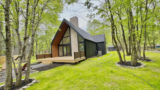 2154 Valleyview Dr, Bushkill, PA 18324 - rear view of house with a deck, a chimney, a yard, and central AC
